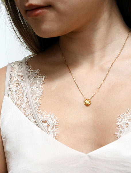 gold seashell necklace modelled