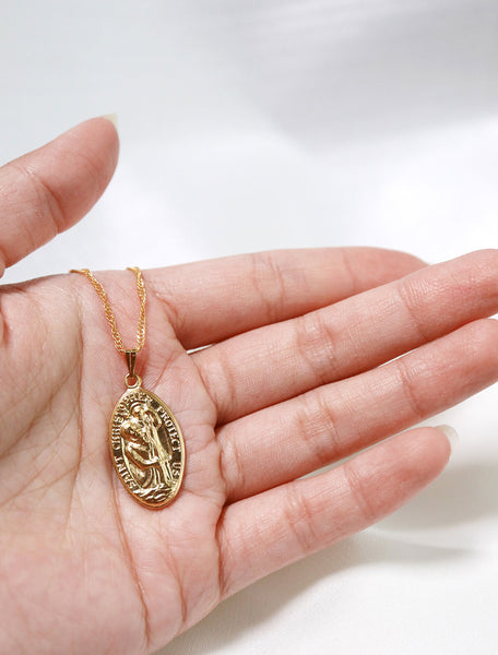 large st. christopher medal in hand