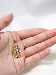 large st. christopher medal in hand