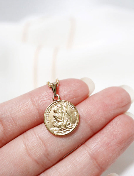close up of tiny st christopher medal