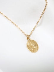 back of tiny starburst cross necklace