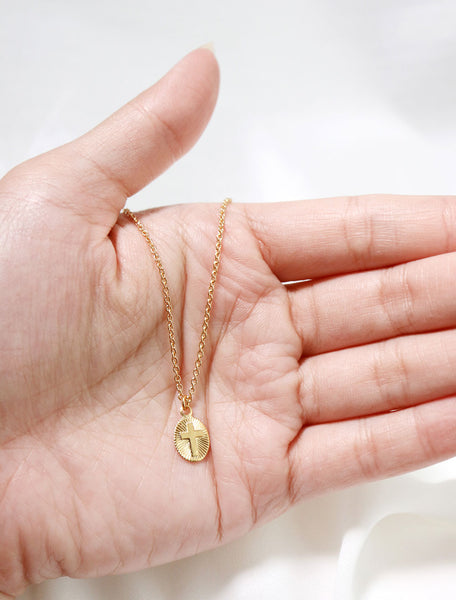 starburst cross pendant in hand