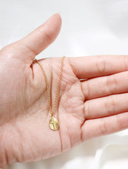 starburst cross pendant in hand