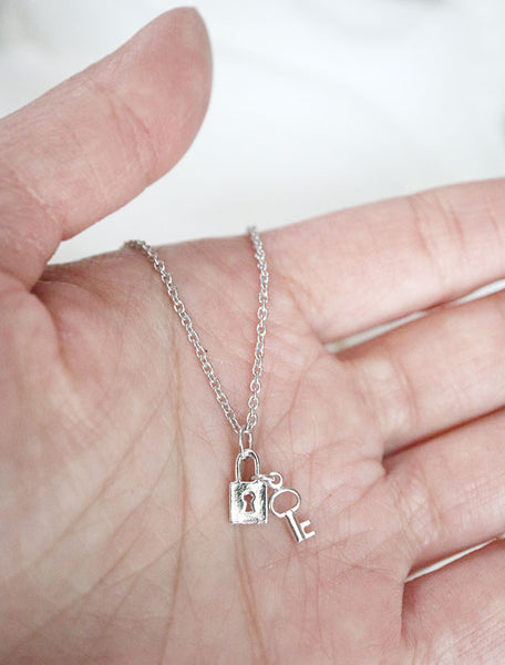 tiny lock and key necklace in hand
