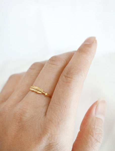 gold feather stacking ring worn