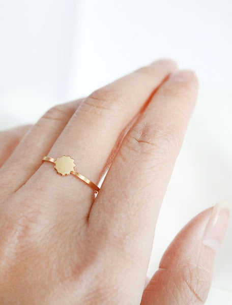 gold scalloped disc ring worn