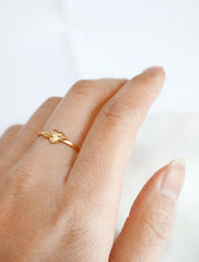 gold heart with arrow ring worn