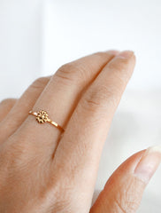 gold tiny daisy ring worn