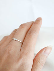 silver triangle ring worn